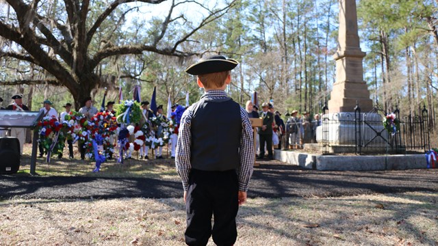 Young Visitor Standing in front of the Grady Monument
