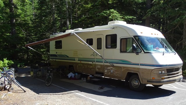 An RV parked at a campsite. 