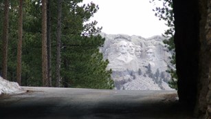 Mount Rushmore viewed through a tunnel on the nearby Iron Mountain Road.