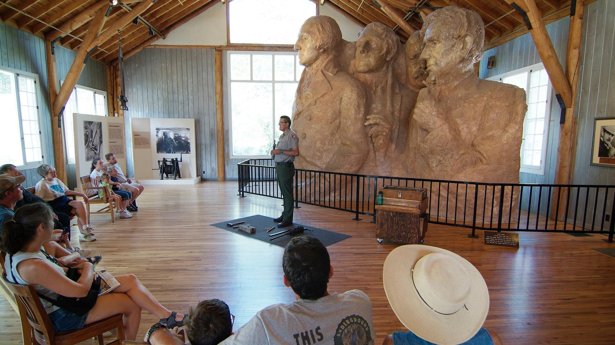 A park ranger describes the carving process inside the Sculptor's Studio.