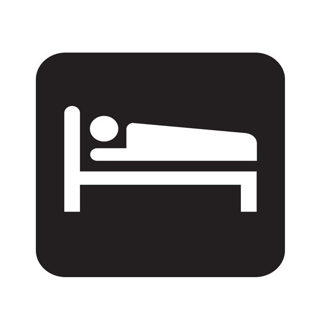 Lodging map symbol with a person sleeping on a bed.
