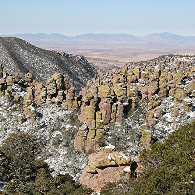 Snow gathers on a rocky outcrop.