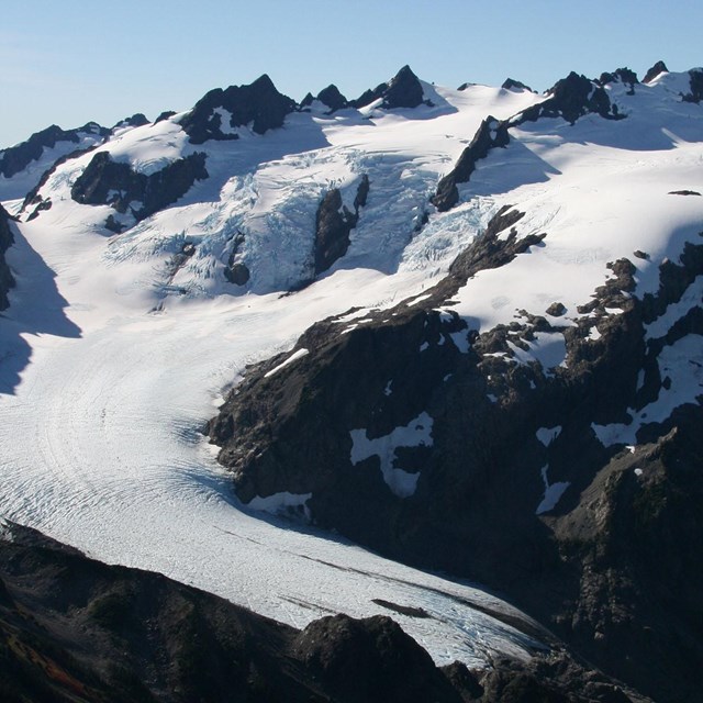 A glacier descends a mountain.