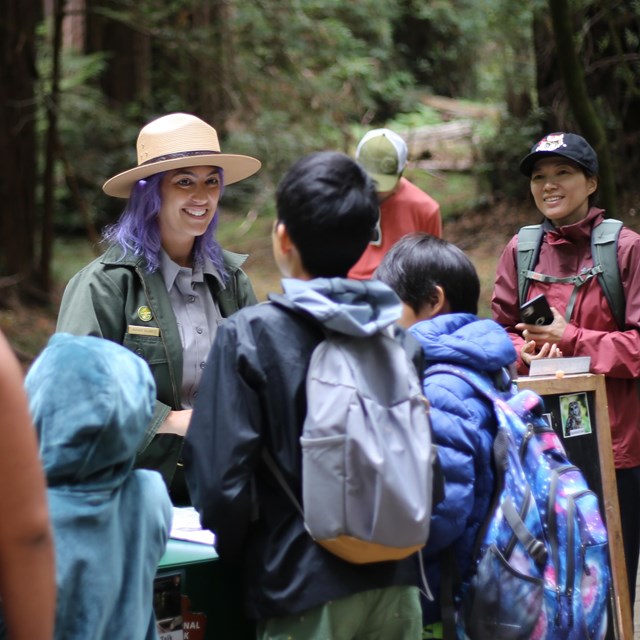 children complete their Junior Ranger promise with a ranger at Muir Woods