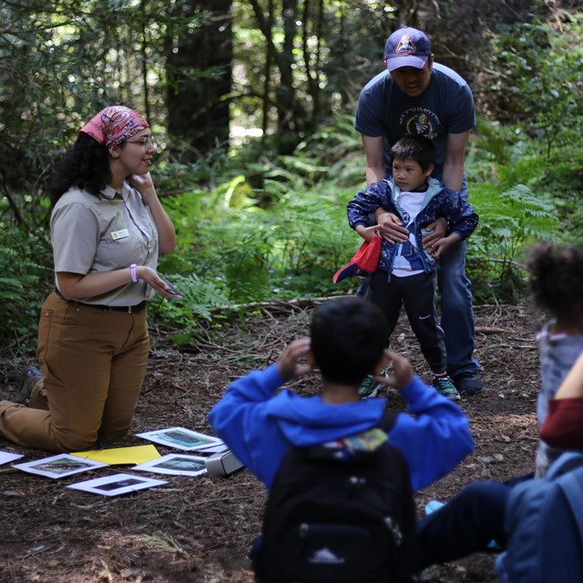 education ranger leads kids group in the woods