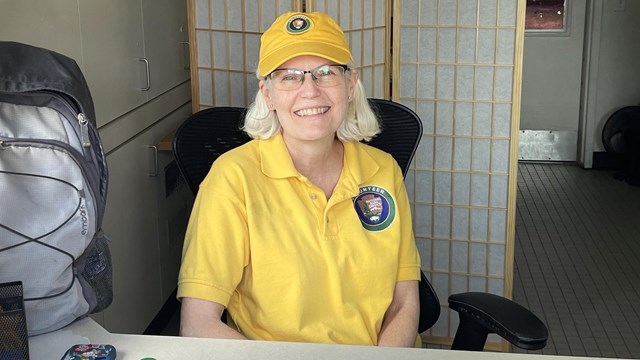 Volunteer in a Kiosk waiting to help visitors 