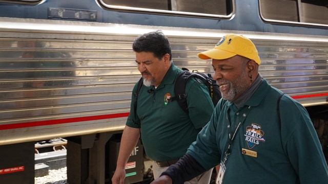 Trails and Rails Volunteer next to a train
