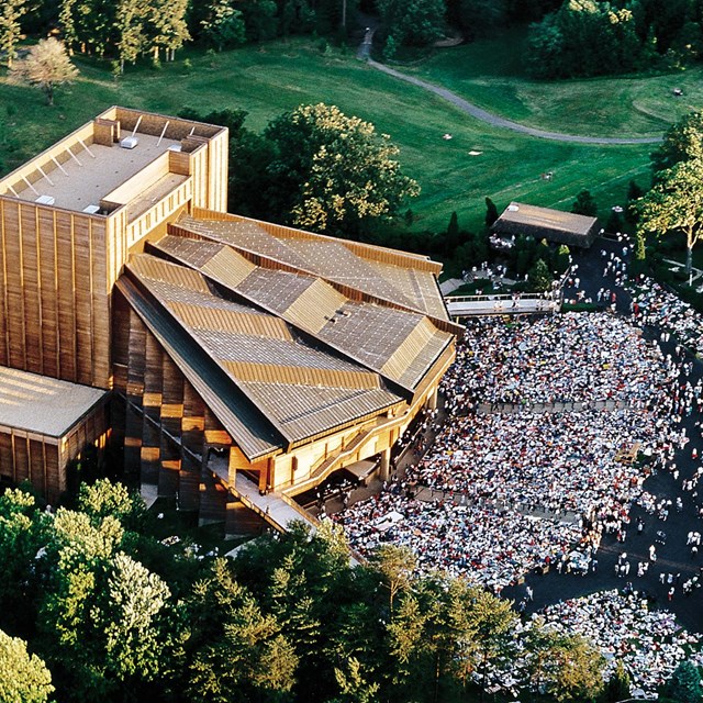 Aerial view of crowd sitting on a theater lawn