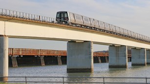Metro train on a bridge over a river