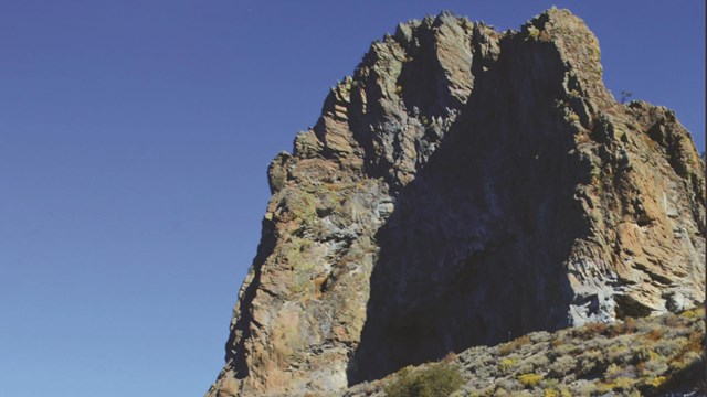 Image of a cliff rising above the waterline