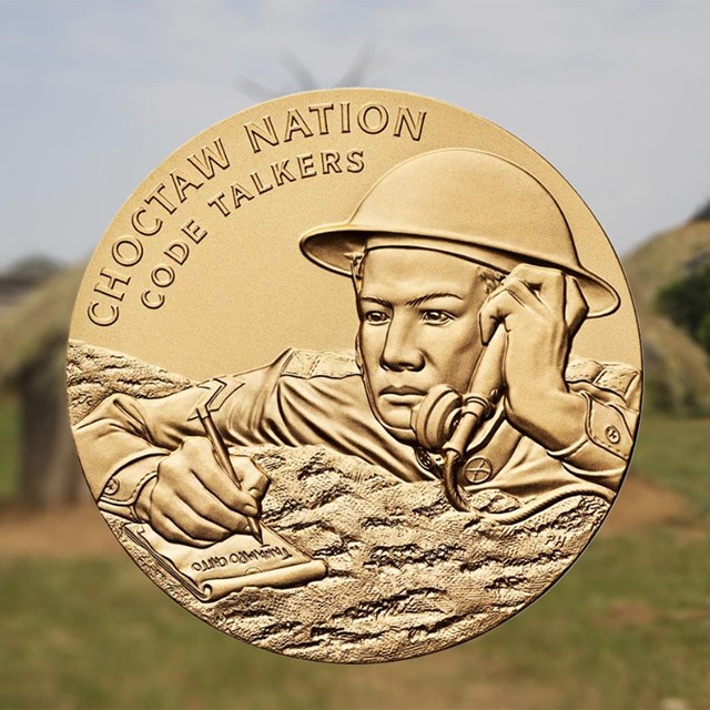 A gold coin with a man in a WW1 helmet superimposed on a blurry pastoral scene.