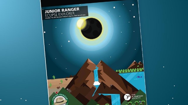 The Eclipse Explorer Junior Ranger book on a night sky blue background