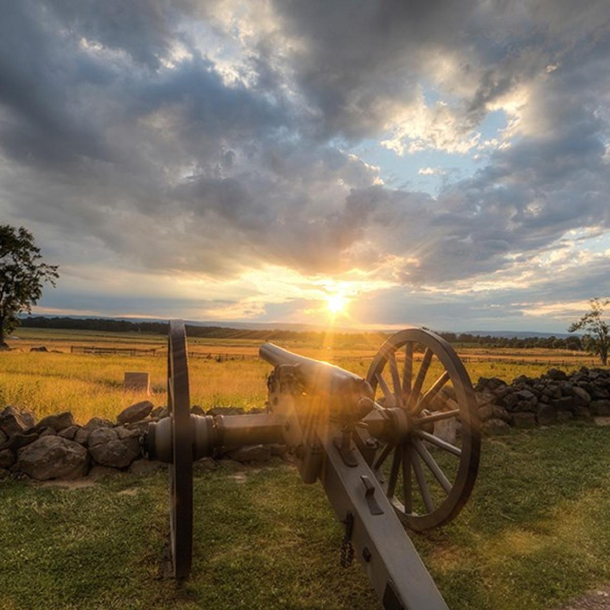 sun shines above a battlefield