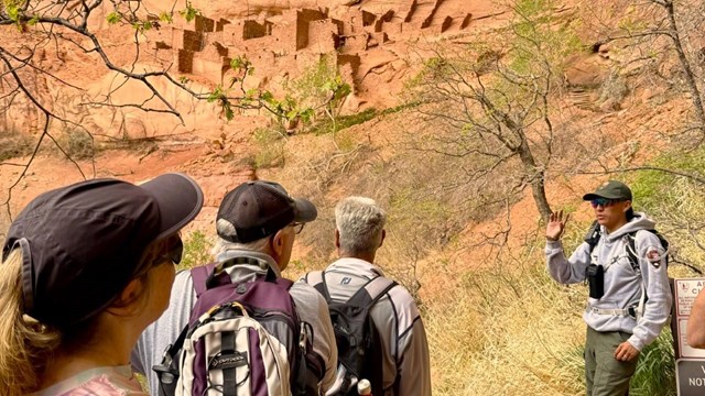 A group visiting Betatakin with a ranger
