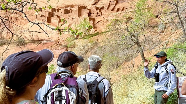 A group visiting Betatakin with a ranger