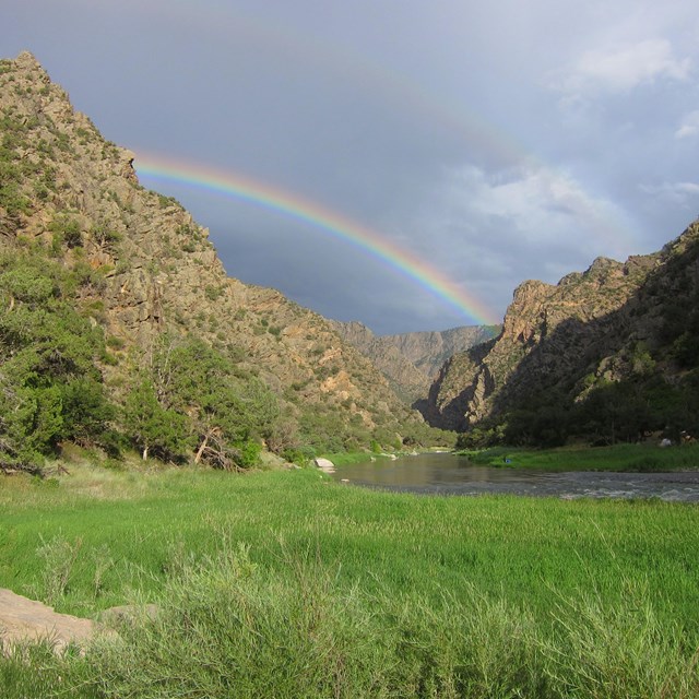 Rainbow over canyon and river