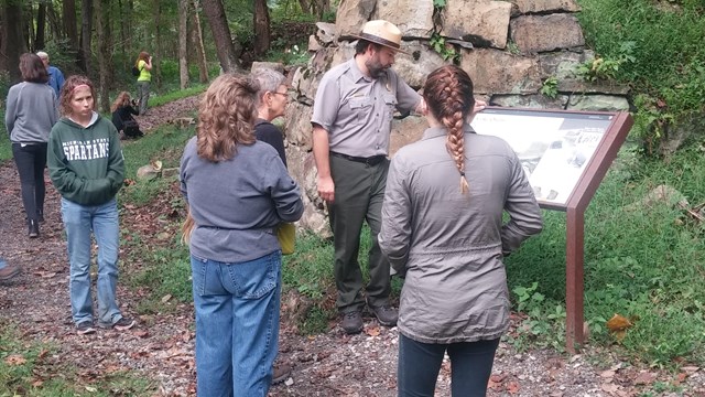 ranger talking to visitors at historic structure