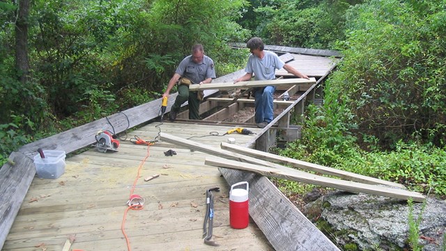 maintenance workers building a boardwalk