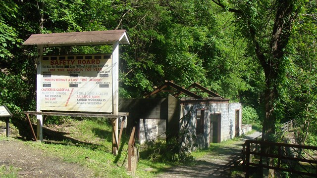 mine safety board and ruins of an old building in the woods