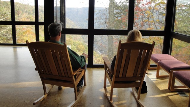 visitors in rocking chairs admire the view