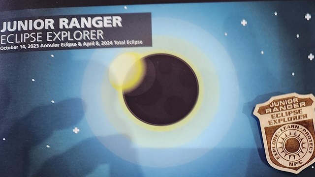 solar eclipse Junior Ranger badge and book