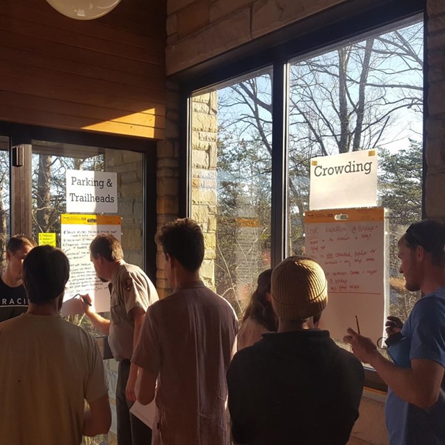 people engaged in a meeting in a park visitor center
