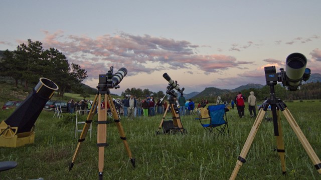 Telescopes on grassy field for astronomy event. Rocky Mountain National Park