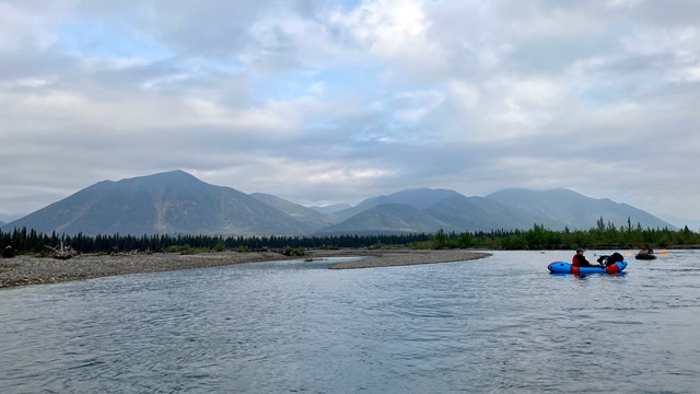 Two visitors float down the Kelly River