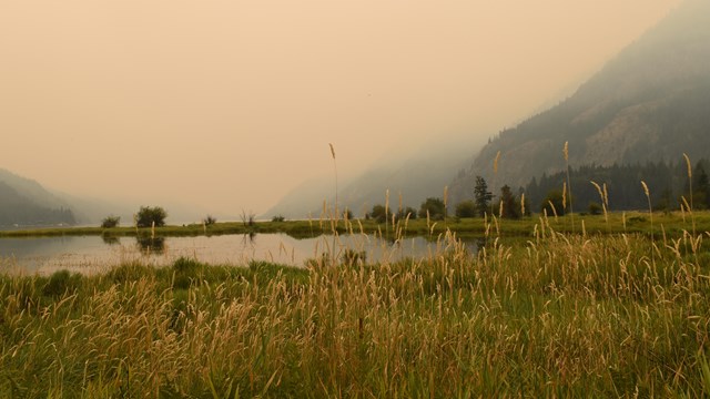 Haze and smoke in the sky with a lake