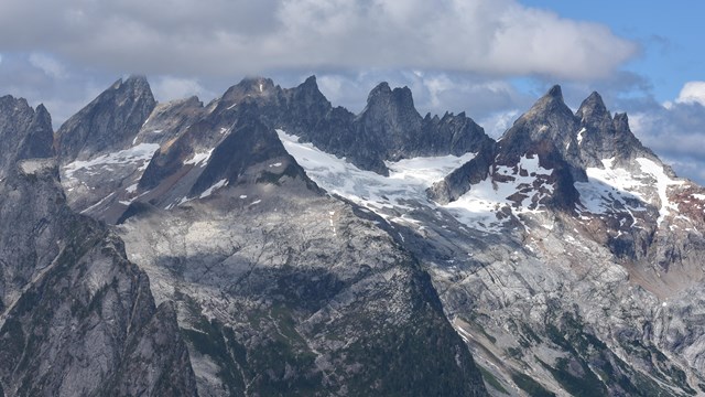 Mountain range with steep peaks and some snow