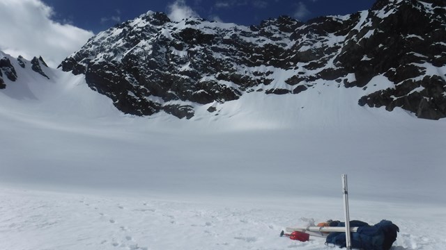 A snowy landscape with tools for glacial monitoring.