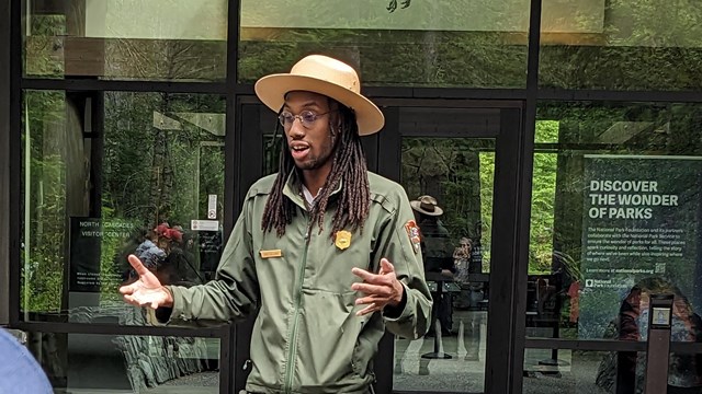 a park ranger speaking and gesturing 