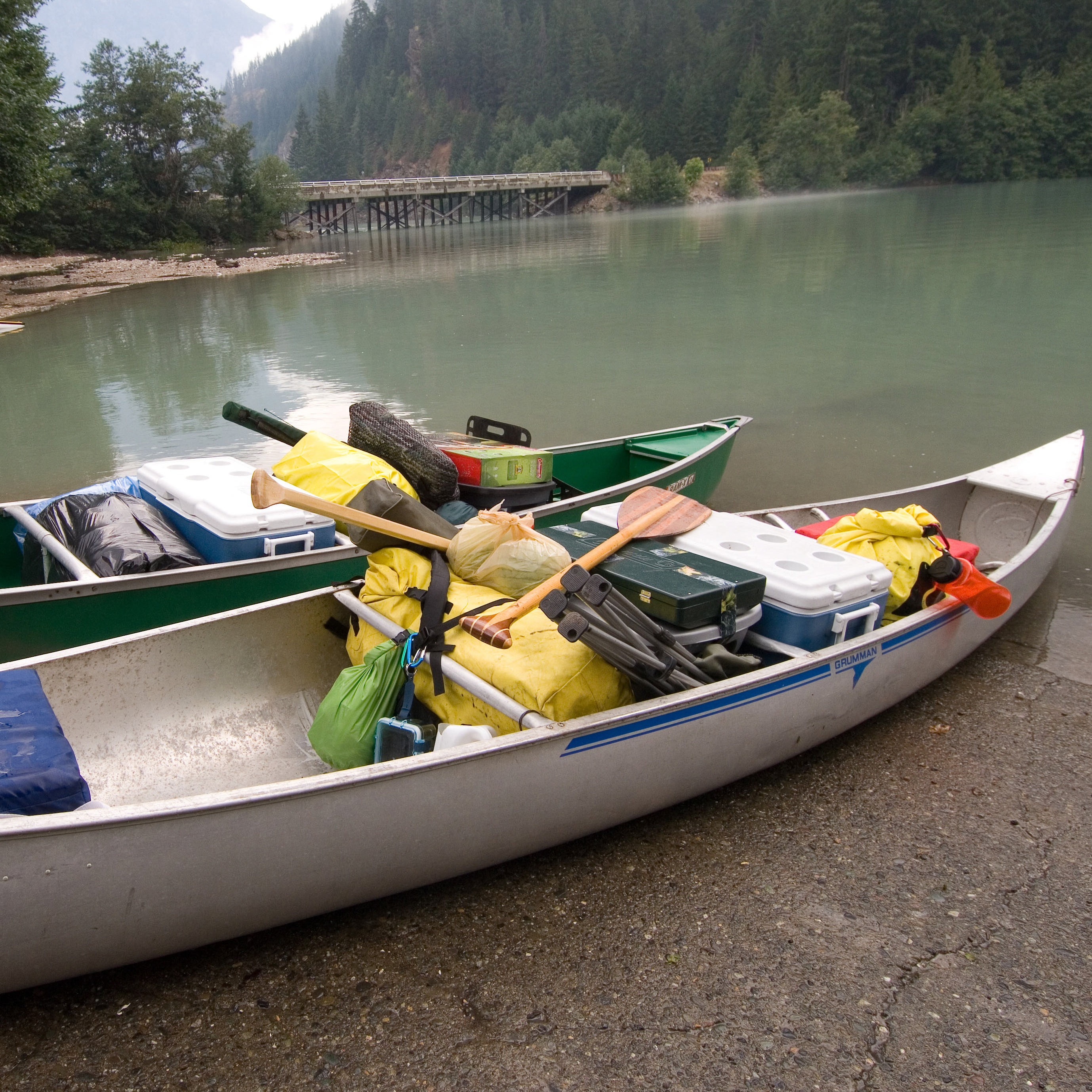 Canoes loaded for camping  prepare to launch at the lakes edge. 