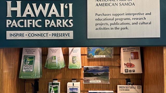 Indoors; Close up of Wooden display with souvenirs and poster. 