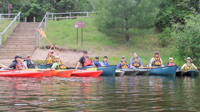 Group of women veterans in a line of kayaks on a river