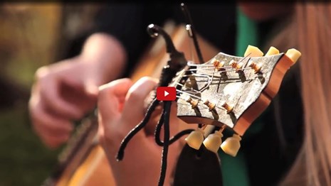 Screenshot of a person's hands playing guitar 