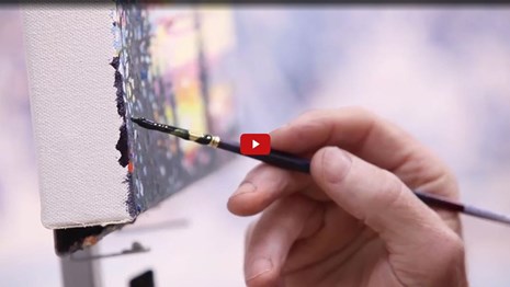 Screenshot of a hand holding a paint brush painting on a canvas