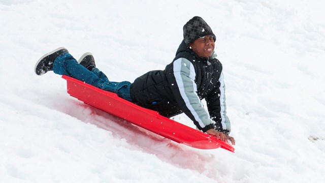 Kid sledding in the snow