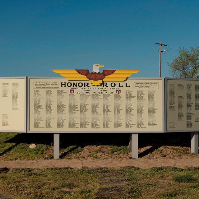 Three panels listing the names of many Americans who served in World War II