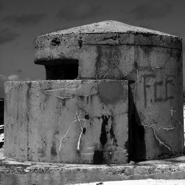 Historical image of a concrete pillbox structure on a beach