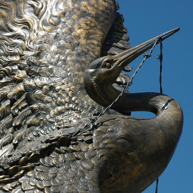 Metal statue of a crane