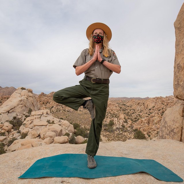 Ranger doing a yoga pose in the desert