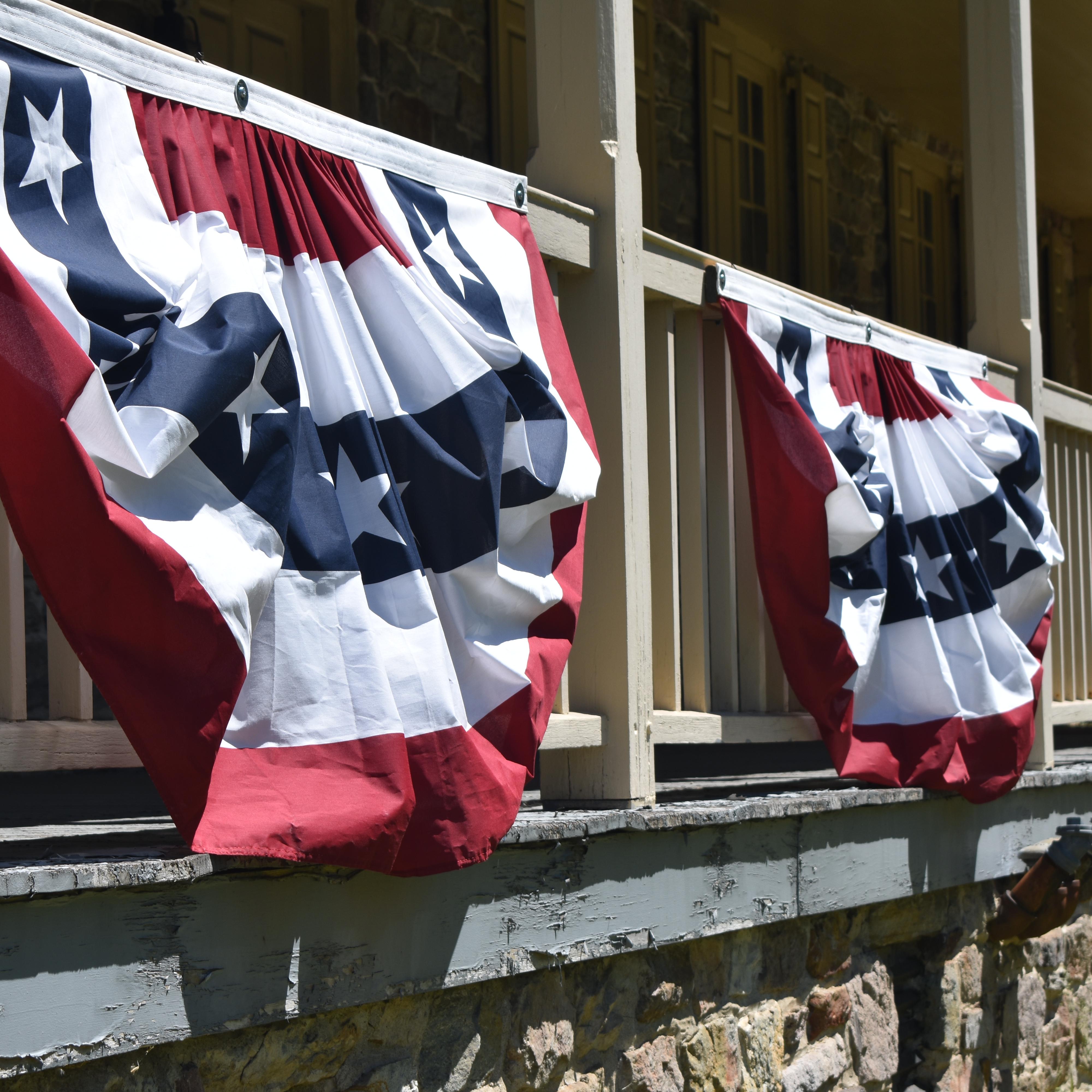 Semi-circular patriotic banners hanging from a poch