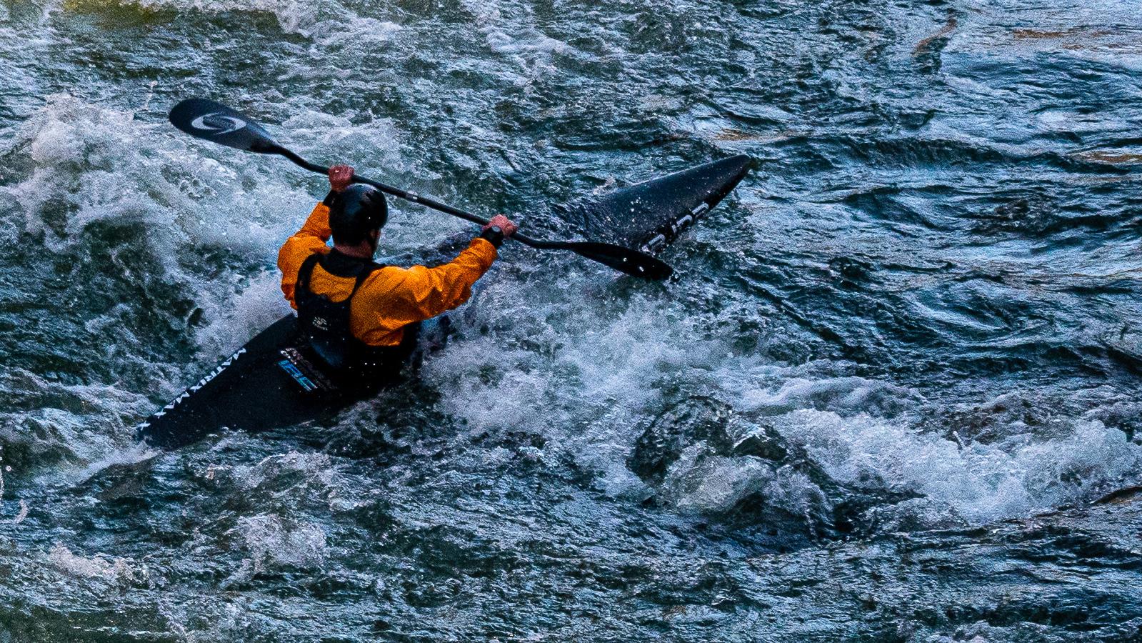 A paddler in river water