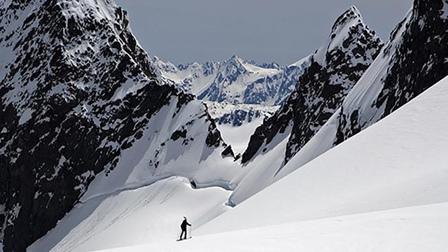 A researcher skis across a glacier