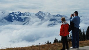 Two people overlook mountain vistas at Hurricane Ridge