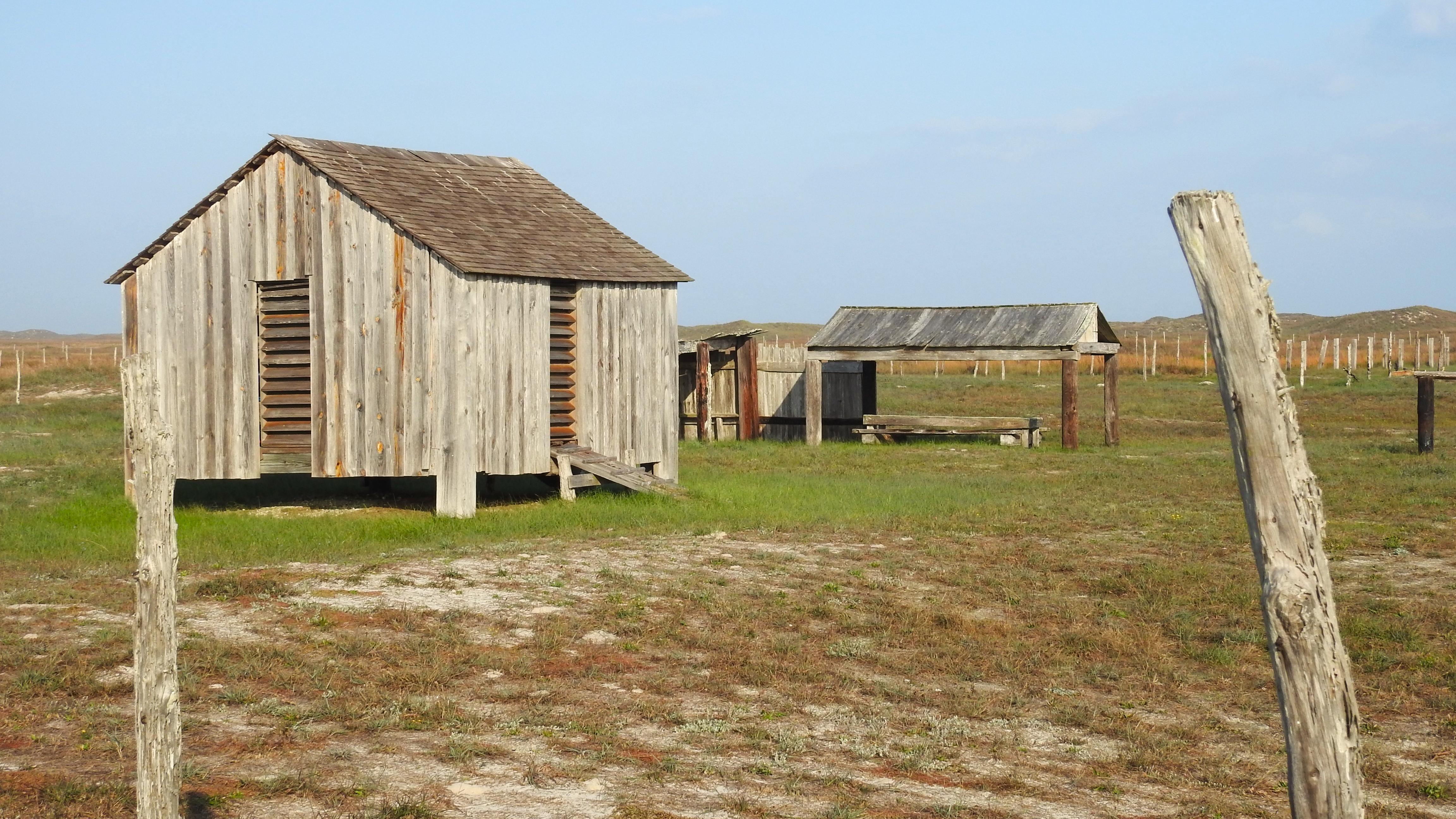A small group of historic wooded ranch buildings. 