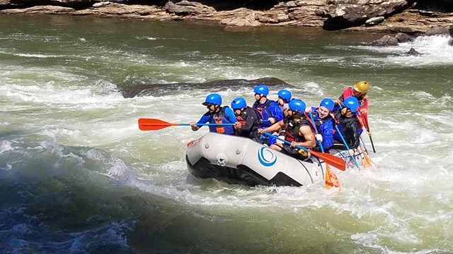 Rafters paddling through whitewater.