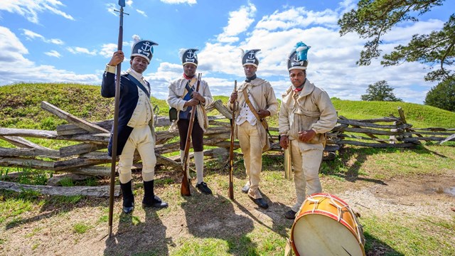 Reenactors dressed as the Revolutionary War's 1st Rhode Island Regiment