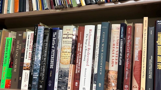 A bookshelf filled with a variety of books.